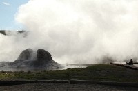 Walking around the geyser fields at Old Faithful - Michelle taking in the steam.