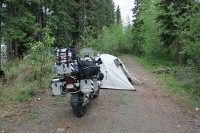 About 200 miles from Whitehorse, I pitched a tent to stay out of the rain while I tried to arrange a tow to Dawson City.